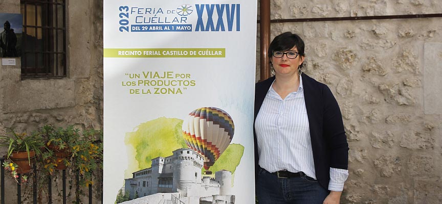 La concejala de Desarrollo Económico, Raquel Gilsanz posa junto a una imagen promocional de la Feria de CUéllar 2023. | Foto: Gabriel Gómez | 